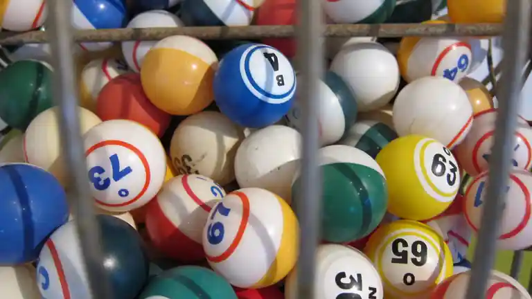 Numbered balls piled up inside a wire drum