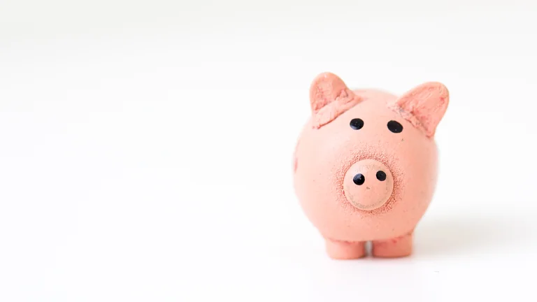 A small pink piggy bank on a white table