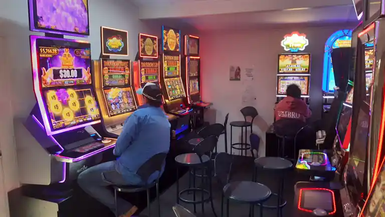 Rows of brightly lit poker machines in a country hotel's gaming room