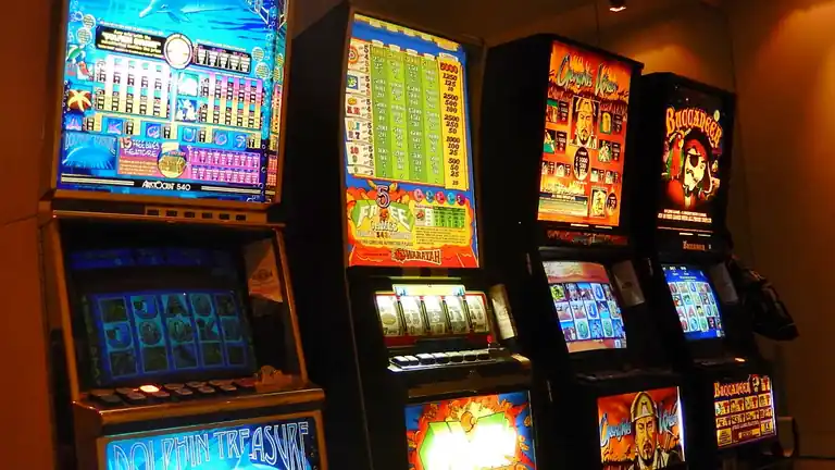 A bank of poker machines with bright, flashing screens